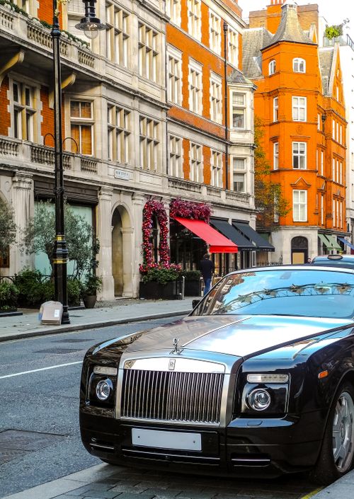 Free Luxury car parked on a stylish historic street in London, showcasing classic architecture. Stock Photo