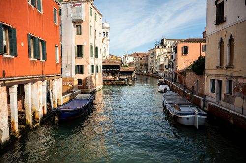 Free Charming view of a Venetian canal surrounded by colorful historic buildings in Venice, Italy. Stock Photo