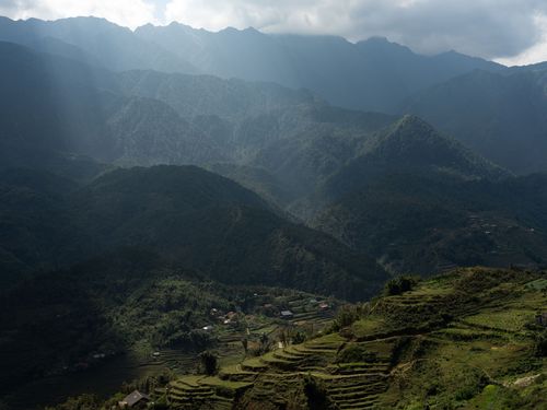 Free Majestic mountains and terraced fields under dramatic sky in Lào Cai, Vietnam. Stock Photo