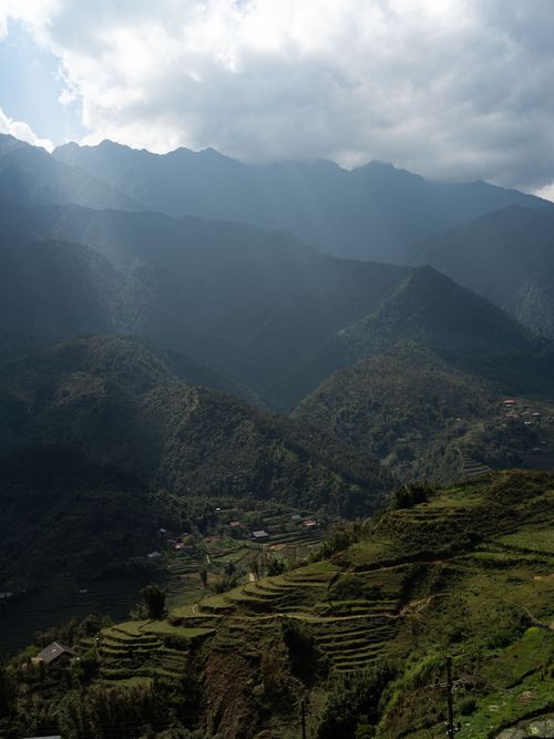 Free Sunlit mountain landscape with terraced fields in Lào Cai, Vietnam. Stock Photo