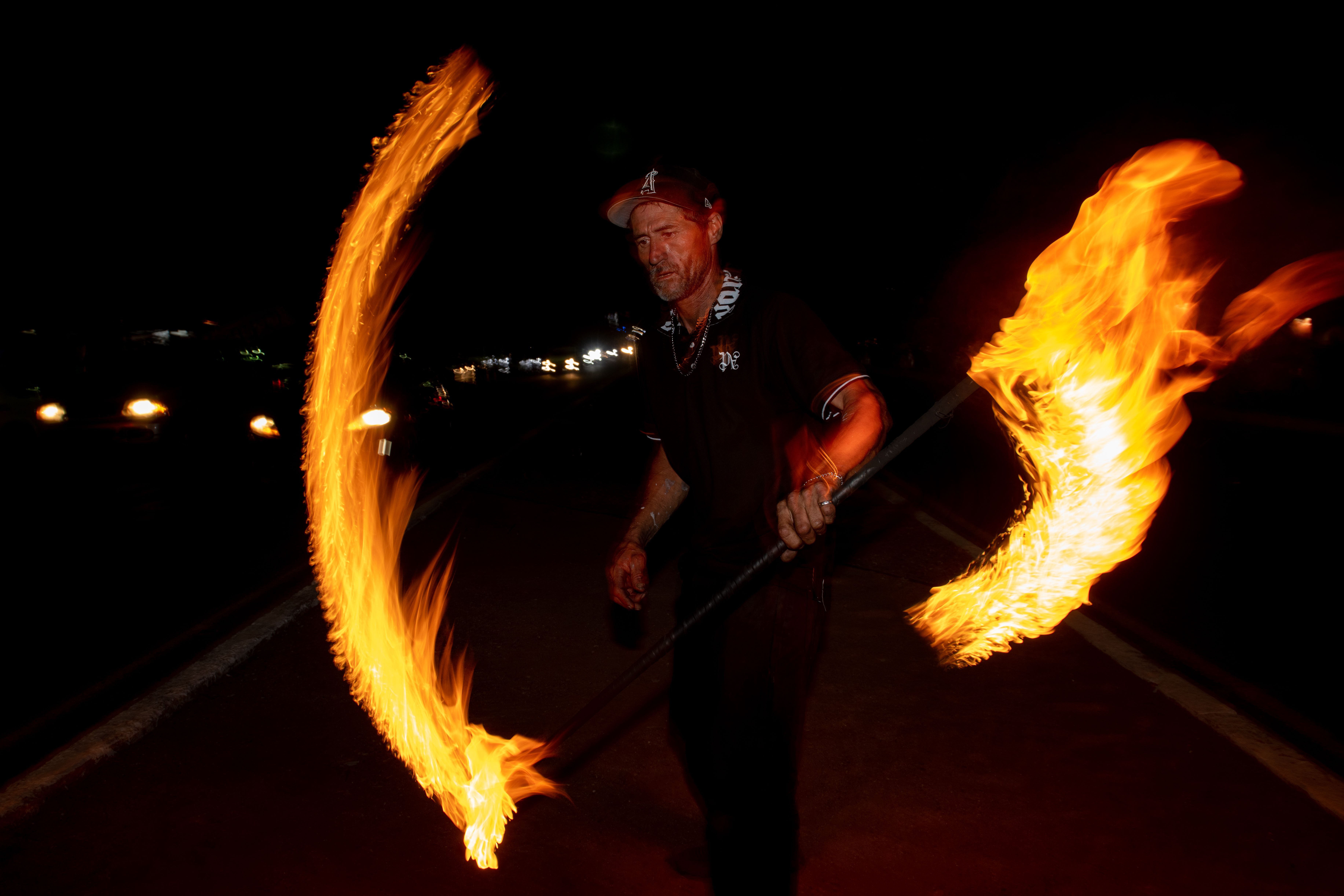 Fire Performer Wielding Flaming Staff in Nighttime Show · Free Stock Photo