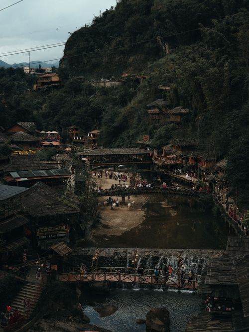 Free A picturesque view of a traditional village in Lào Cai, Vietnam, surrounded by lush greenery. Stock Photo