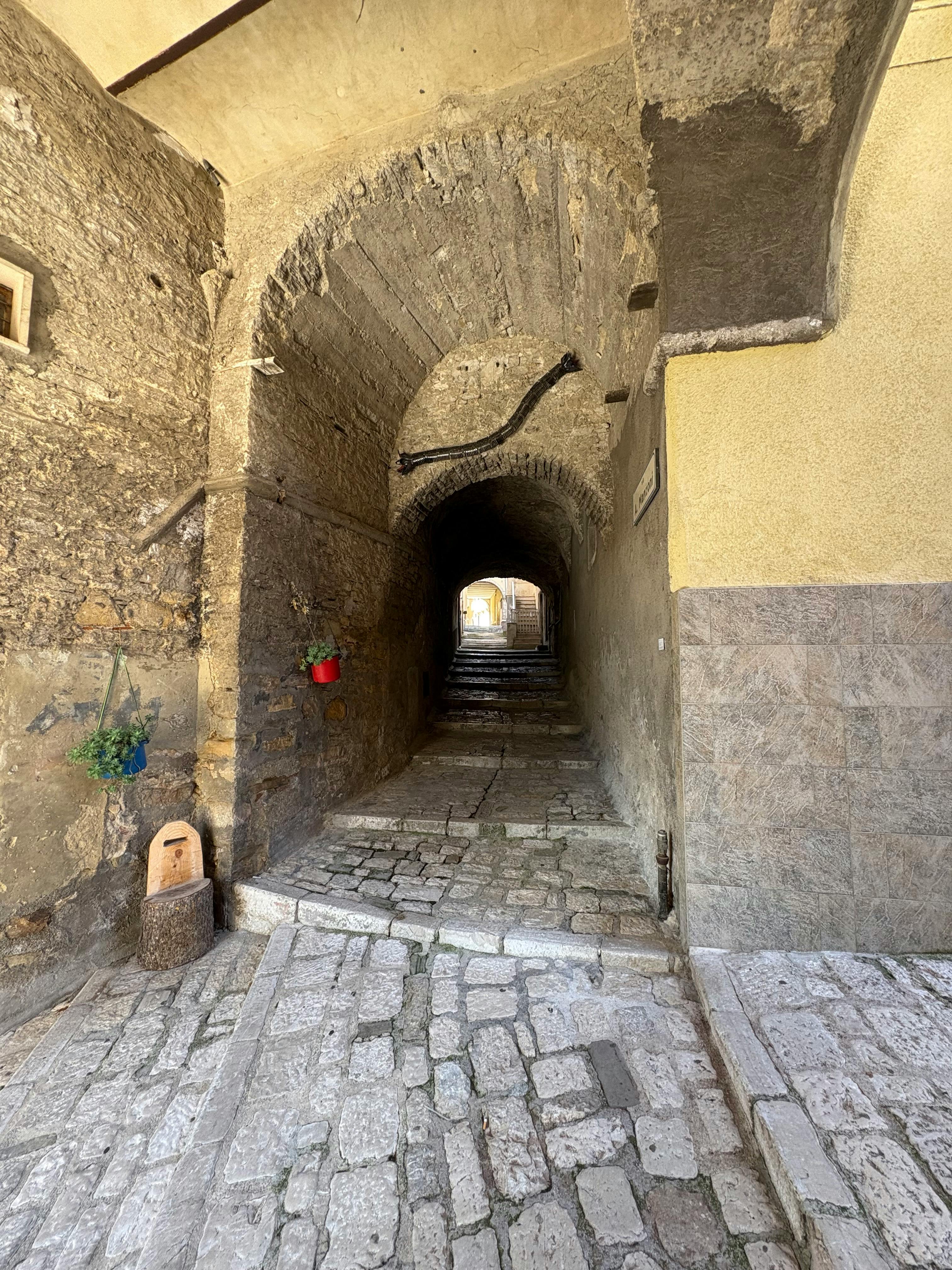 бесплатная Очаровательная мощеная улочка в Исернии, Италия, демонстрирующая историческую архитектуру. Стоковое фото