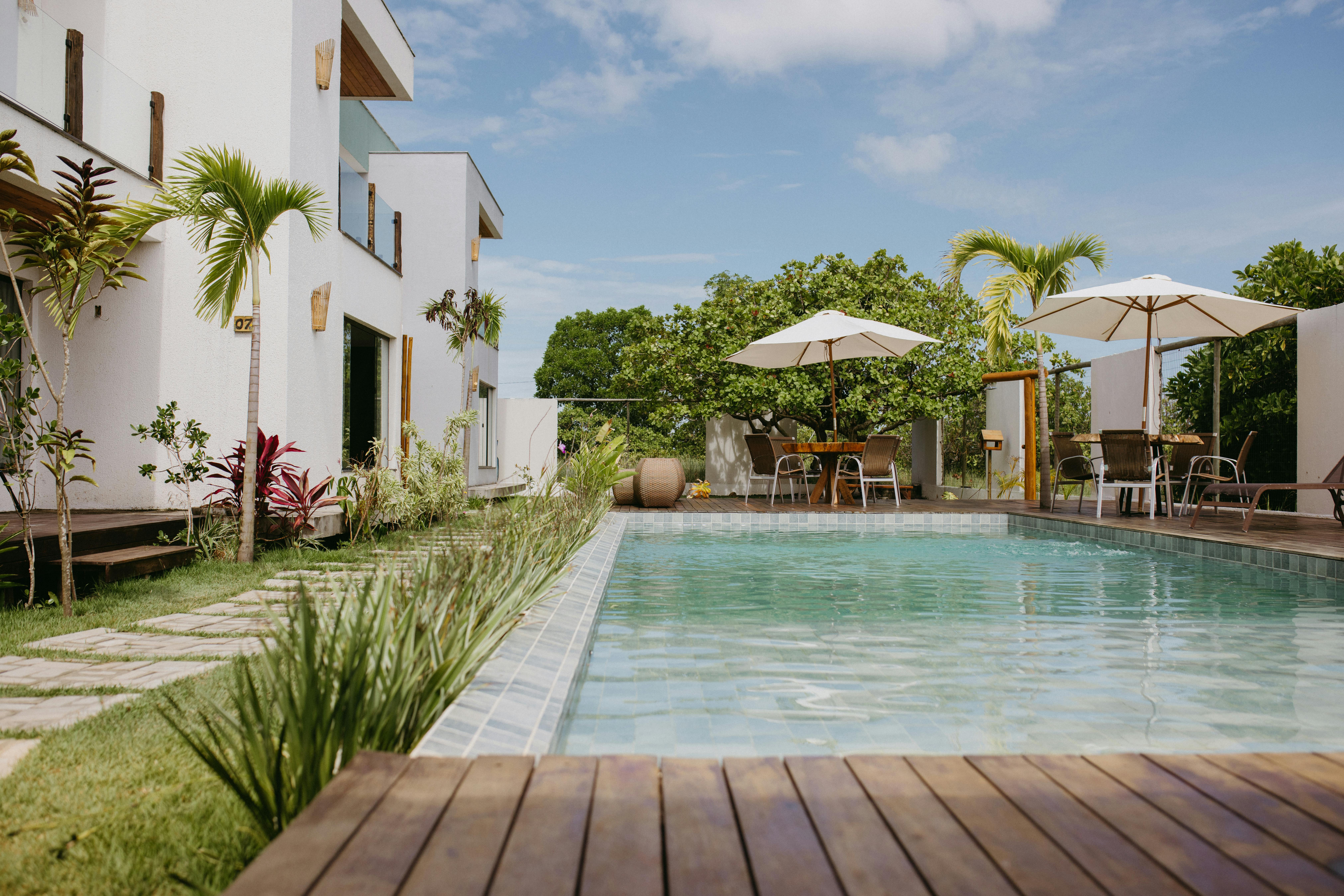 Free Beautiful modern villa with a pool surrounded by lush greenery in Bahia, Brazil. Stock Photo