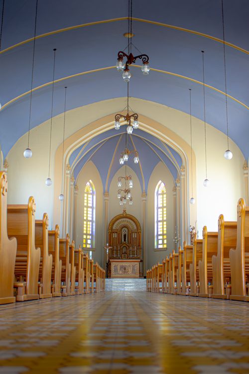 Free Elegant church interior showcasing altar and arches with natural lighting. Stock Photo