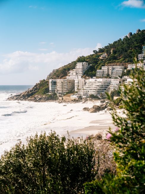 Sunny view of Cape Town's stunning beachfront with waves crashing against the shore.