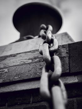 A close-up black and white photo capturing a metal chain.