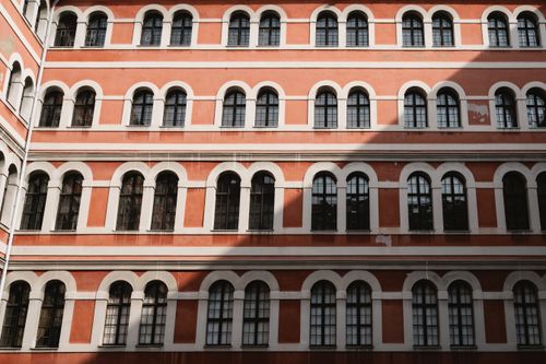Free Elegant historic building facade with aligned arched windows, perfect for architecture and design inspiration. Stock Photo