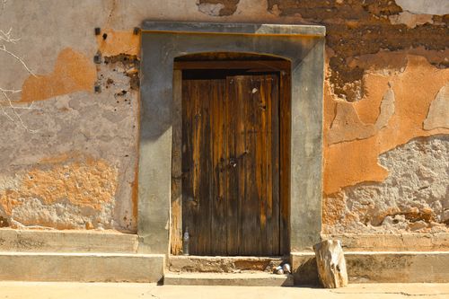 Free Charming rustic wooden door against a weathered wall in Sahuaripa, Sonora, Mexico. Stock Photo