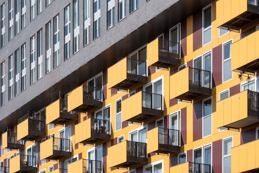 Contemporary architecture featuring bold yellow balconies of a city apartment building.
