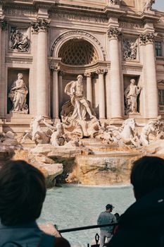 Visitors admire the iconic Trevi Fountain in the heart of Rome, Italy.