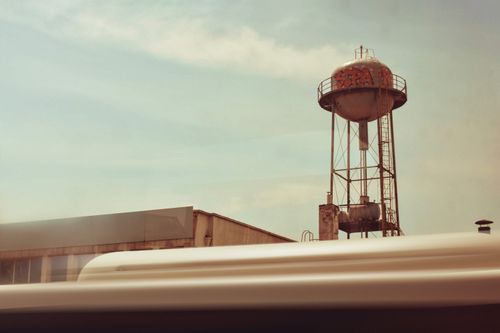 Free Water tower with graffiti seen over bus in motion in Istanbul, Türkiye. Stock Photo