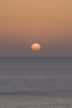 Beautiful sunrise over the Atlantic Ocean with a golden glow in the skies of the Canary Islands.