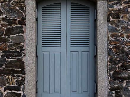 House exterior with newly installed window shutters