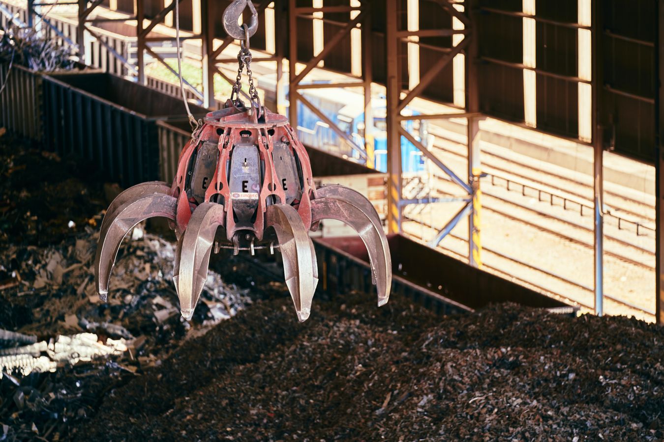 Industrial scrap yard with crane handling recyclable metal