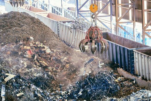 A detailed capture of scrap metal being processed with heavy machinery at a recycling facility.