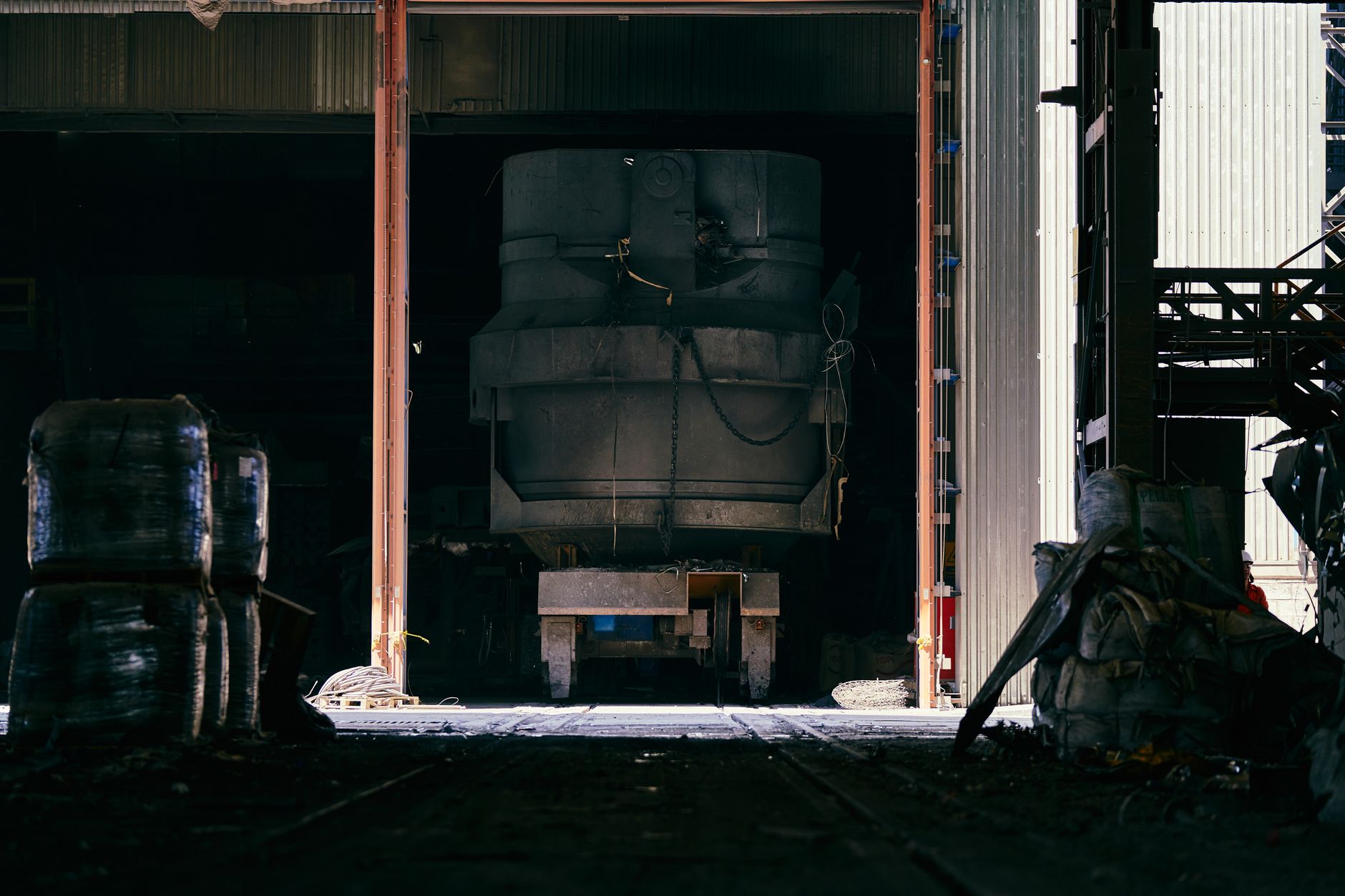 Interior shot of an industrial factory showing large machinery and metal structure.
