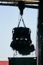 Silhouette of Industrial Scrap Crane Loading Debris