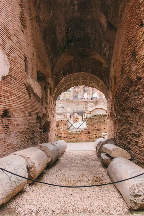 Free Explore the historic interior of the Roman Colosseum with ancient architecture and stone columns. Stock Photo