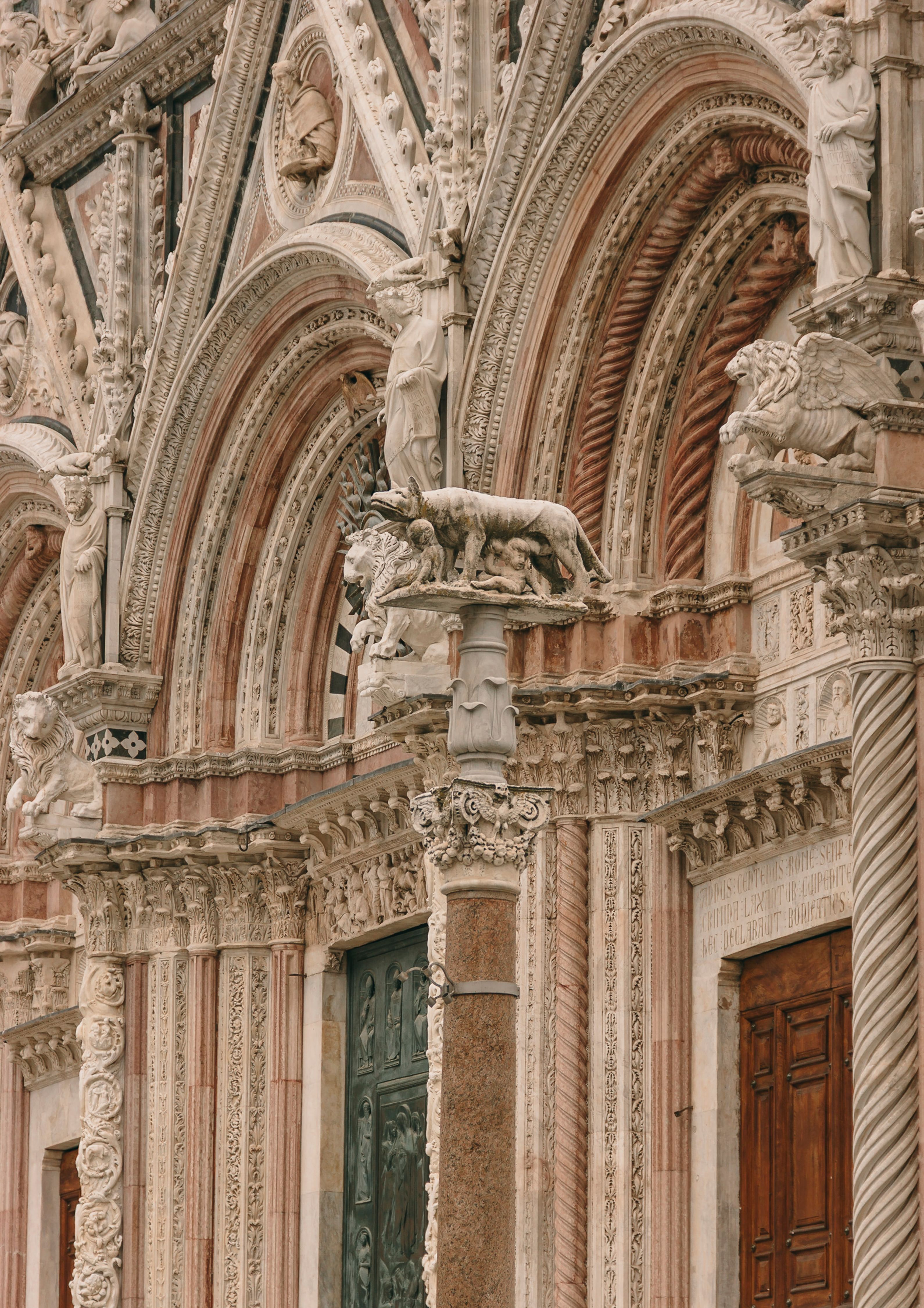 Intricate Gothic facade of a cathedral in Florence, Italy, showcasing detailed sculptures and arches.