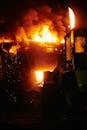 Industrial Fire Scene with Heavy Machinery at Night
