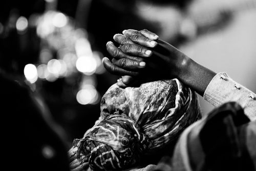 Free Close-up black and white photo of clasped hands in prayer. Peaceful and reflective mood. Stock Photo