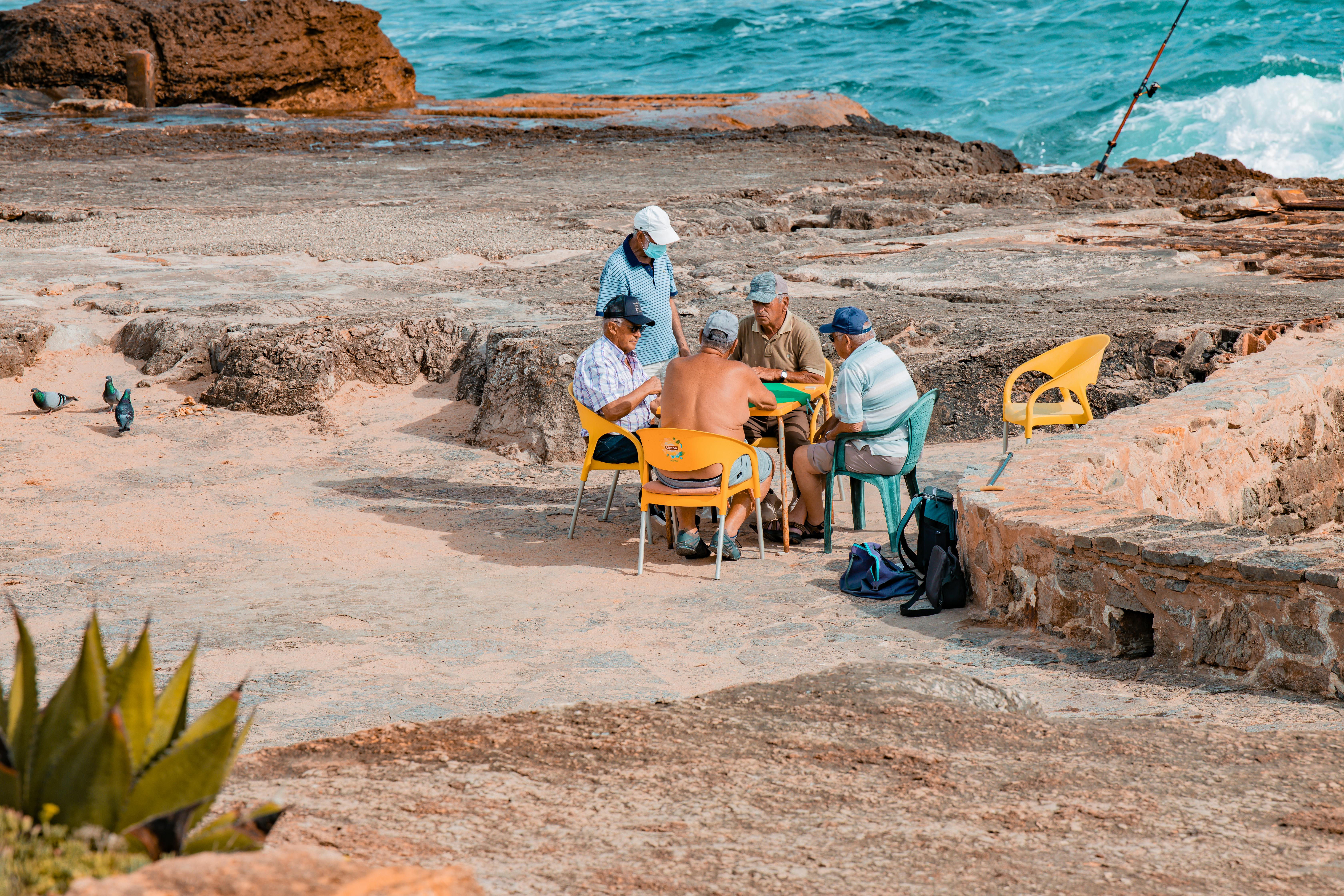 A group of senior men enjoys a game by the ocean in Ericeira, Lisbon, Portugal.