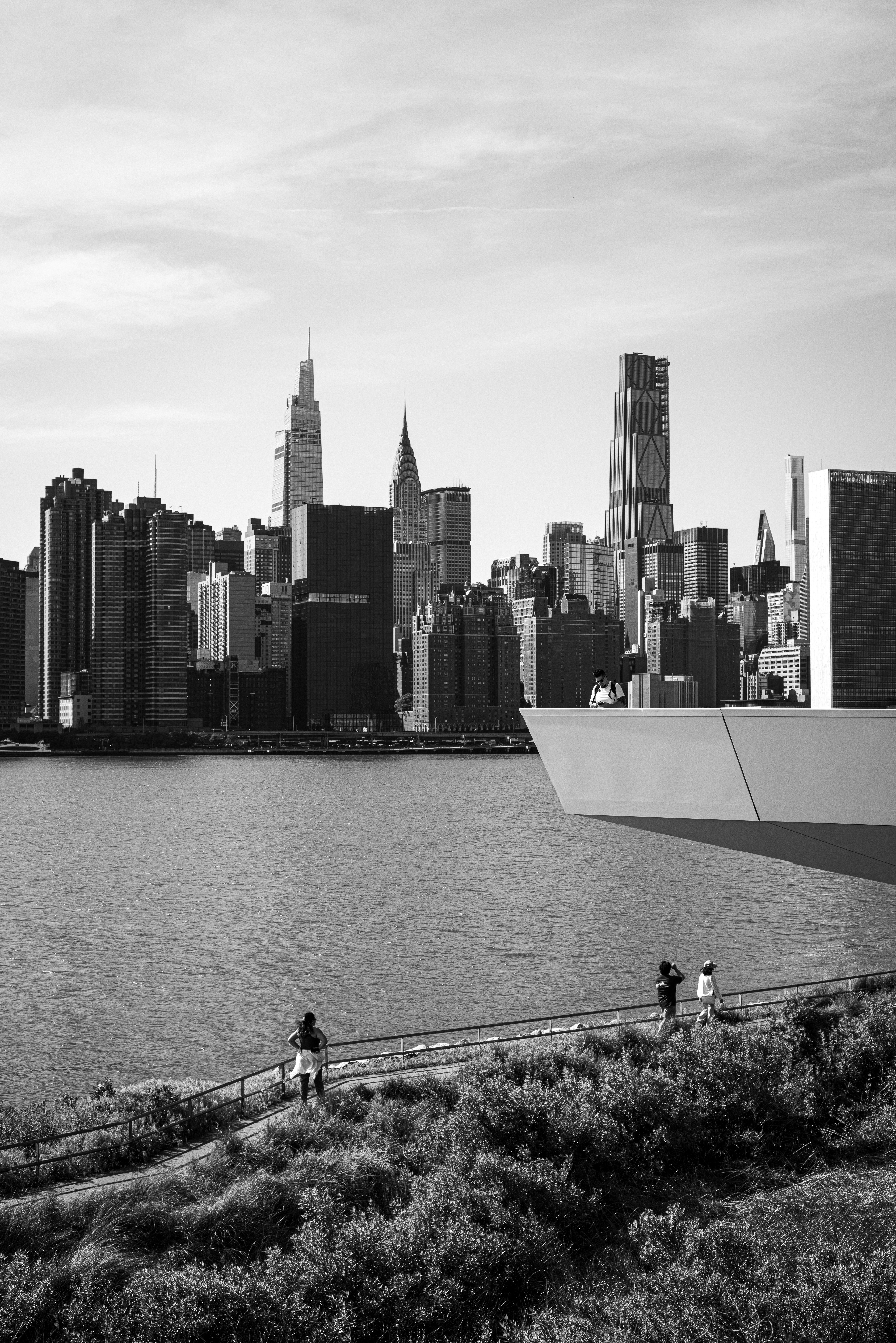 Black and white photograph of the Manhattan skyline featuring the Empire State Building.