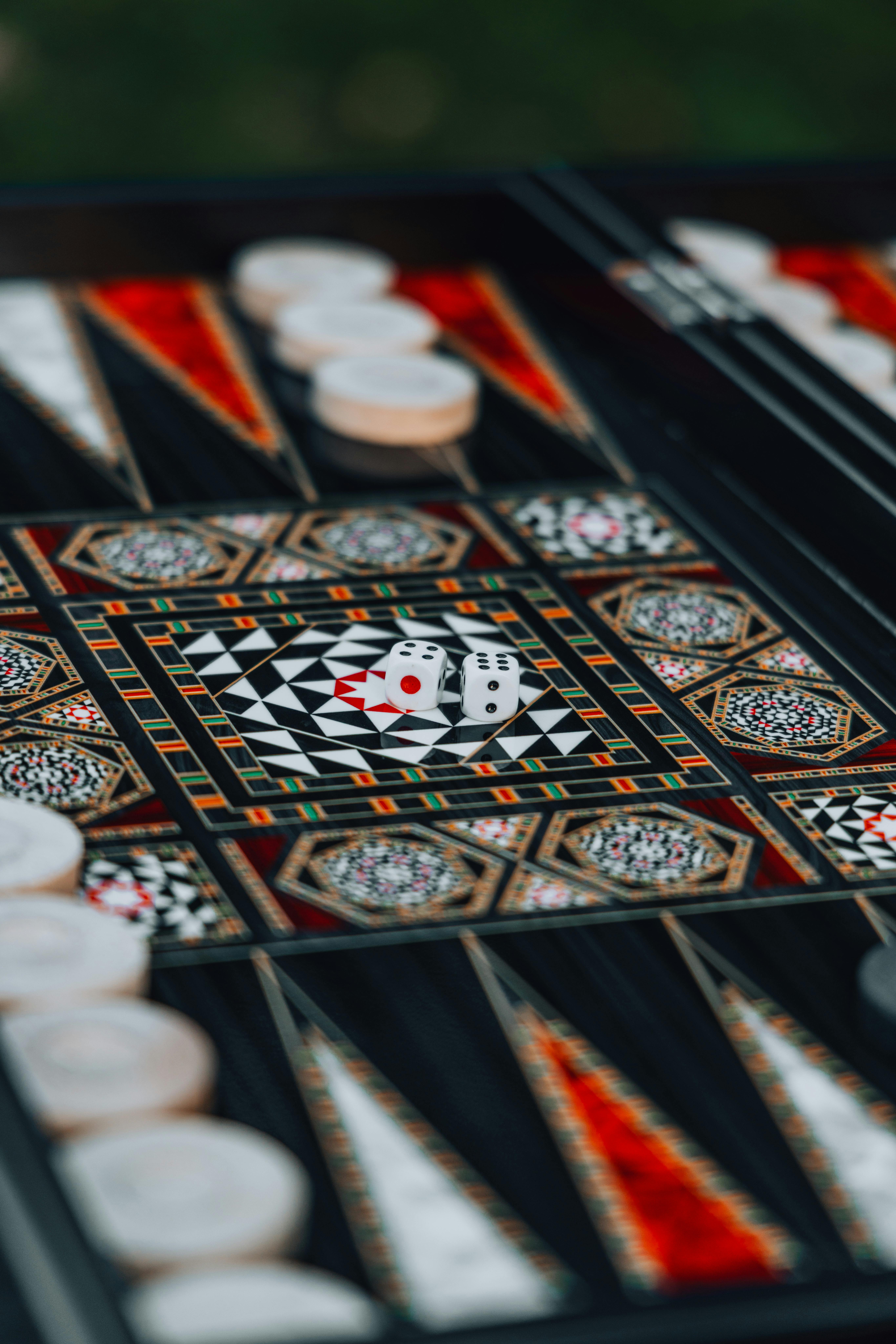 Free Intricate backgammon board with dice, showcasing decorative geometric patterns and game pieces. Stock Photo