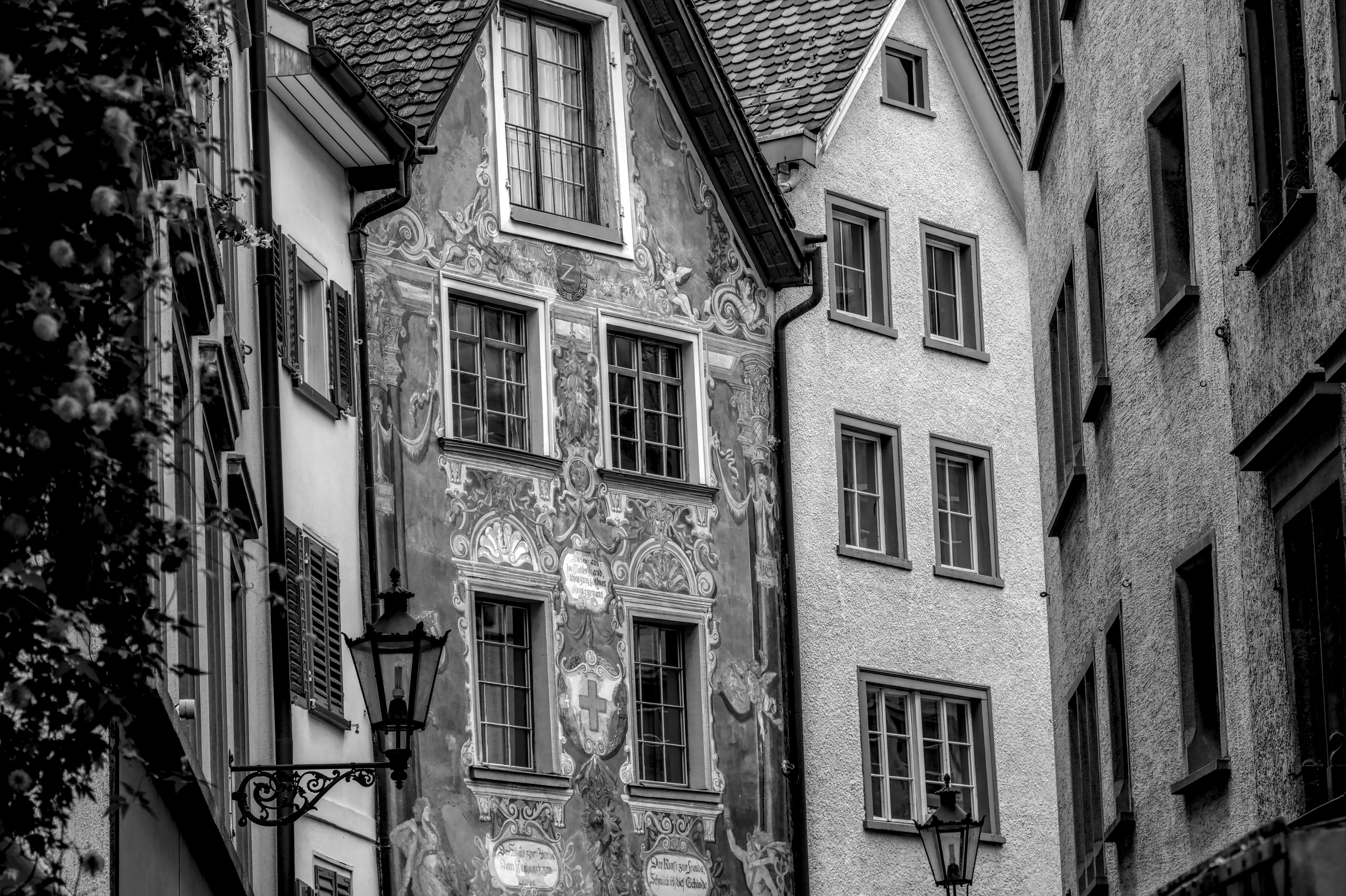 Black and white photo of intricate street facades in Zurich, Switzerland, showcasing historic European architecture.