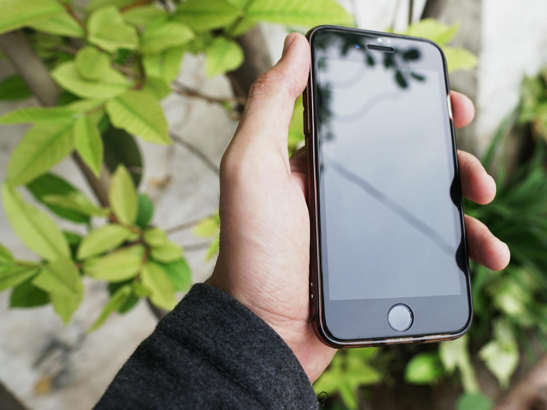 Person Holding Black Iphone 4