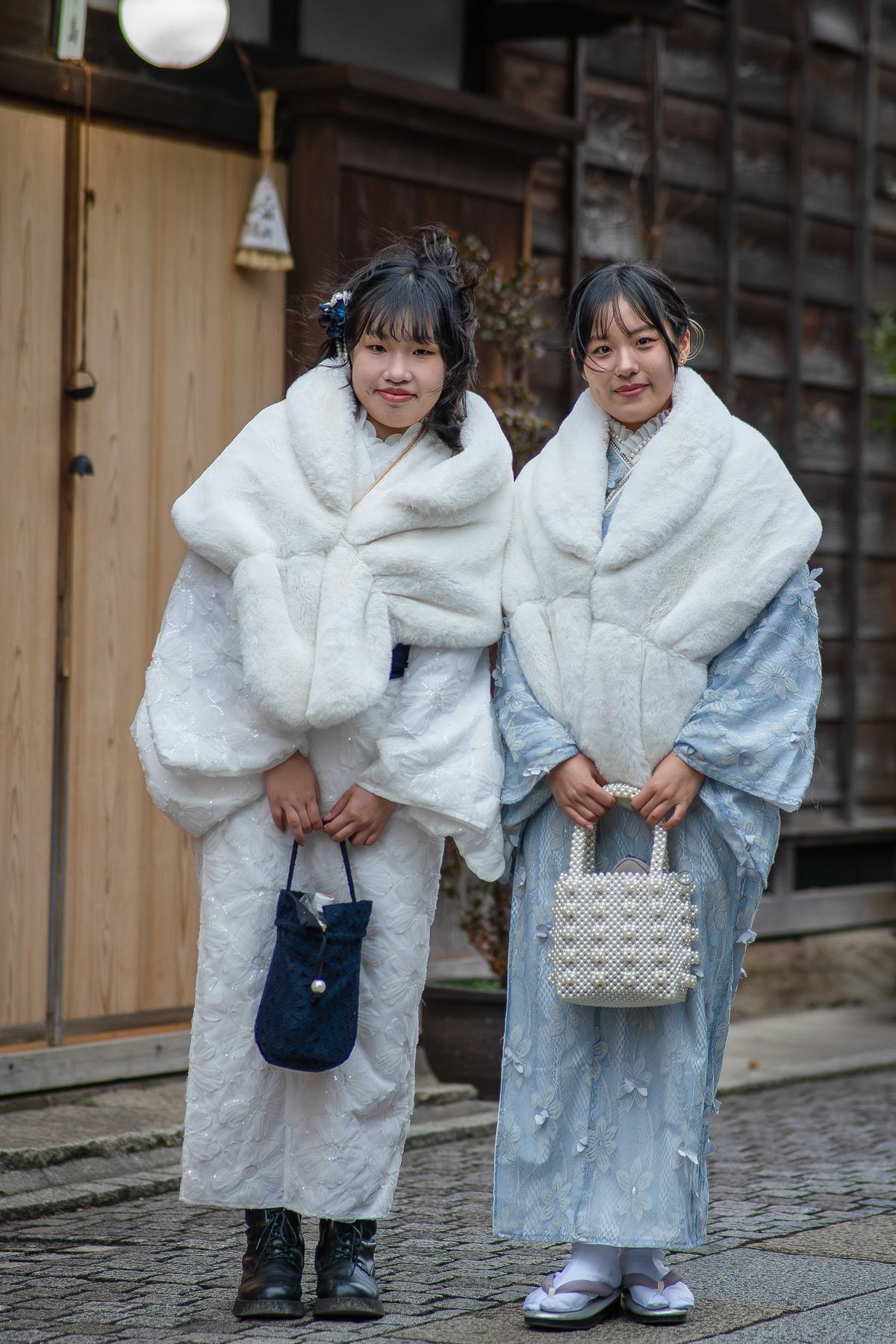 Two young women wearing colorful kimonos walking through the historic streets of Kawagoe, Japan