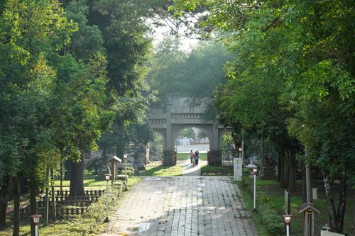 Free A peaceful pathway surrounded by lush greenery in a historic park in Chiayi City, Taiwan. Stock Photo