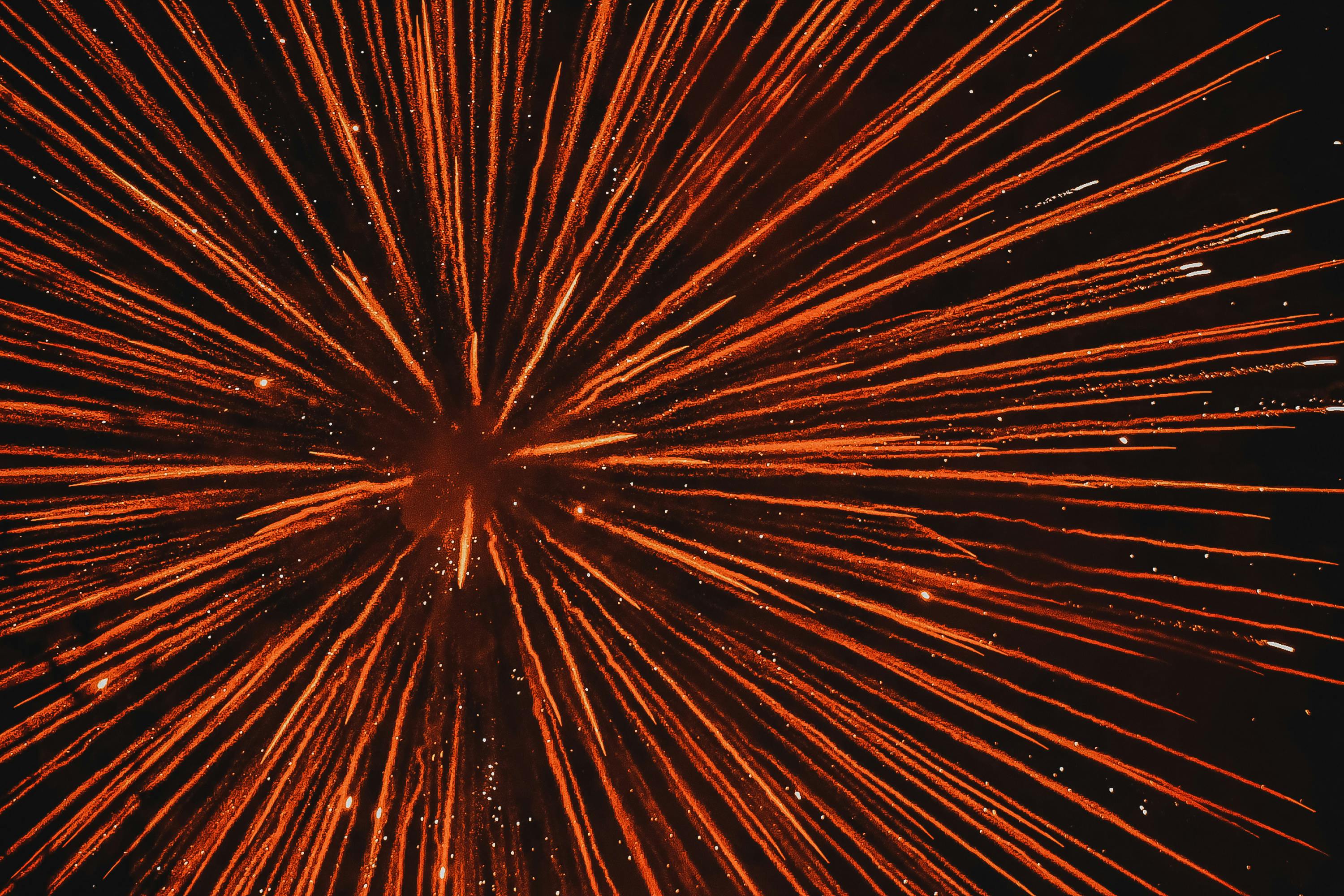 Free A vivid display of red fireworks exploding against a dark night sky. Stock Photo