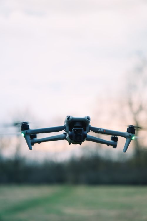 Free Close-up of a drone flying outdoors with a blurred background, suggesting advanced technology. Stock Photo