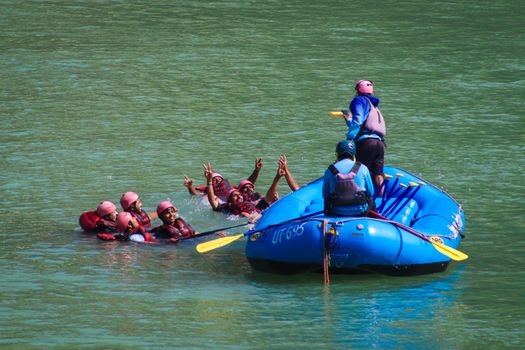 Group rafting experience in Rishikesh with people enjoying the river. Perfect for adventure lovers.