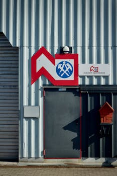 Exterior of industrial building with Zukunft Dachdecker signage and corrugated metal paneling.