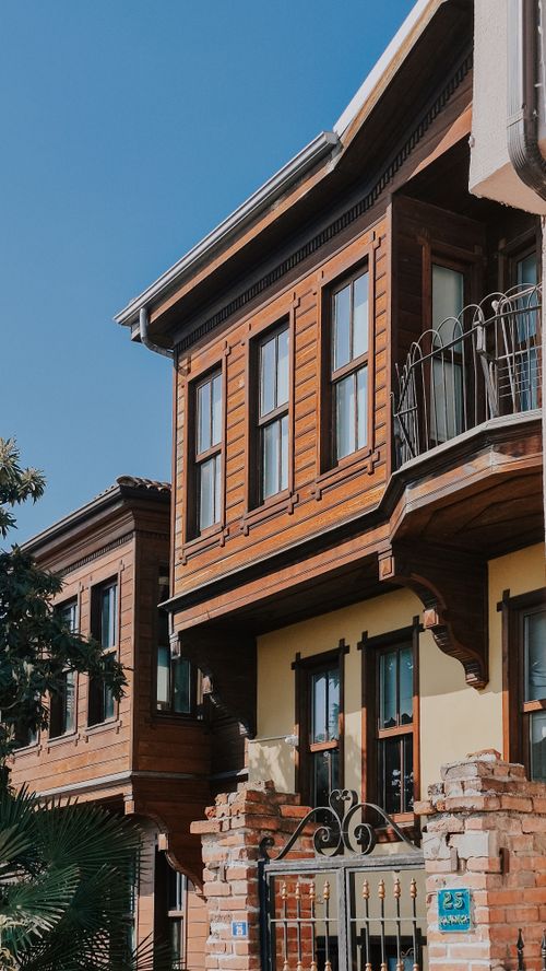 Free A close-up view of a historic wooden building facade under a clear blue sky. Stock Photo