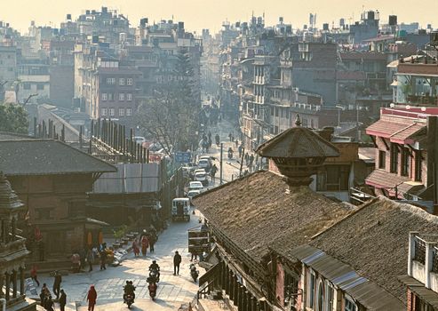 Busy street in Lalitpur, Nepal showcasing traditional architecture and vibrant city life.