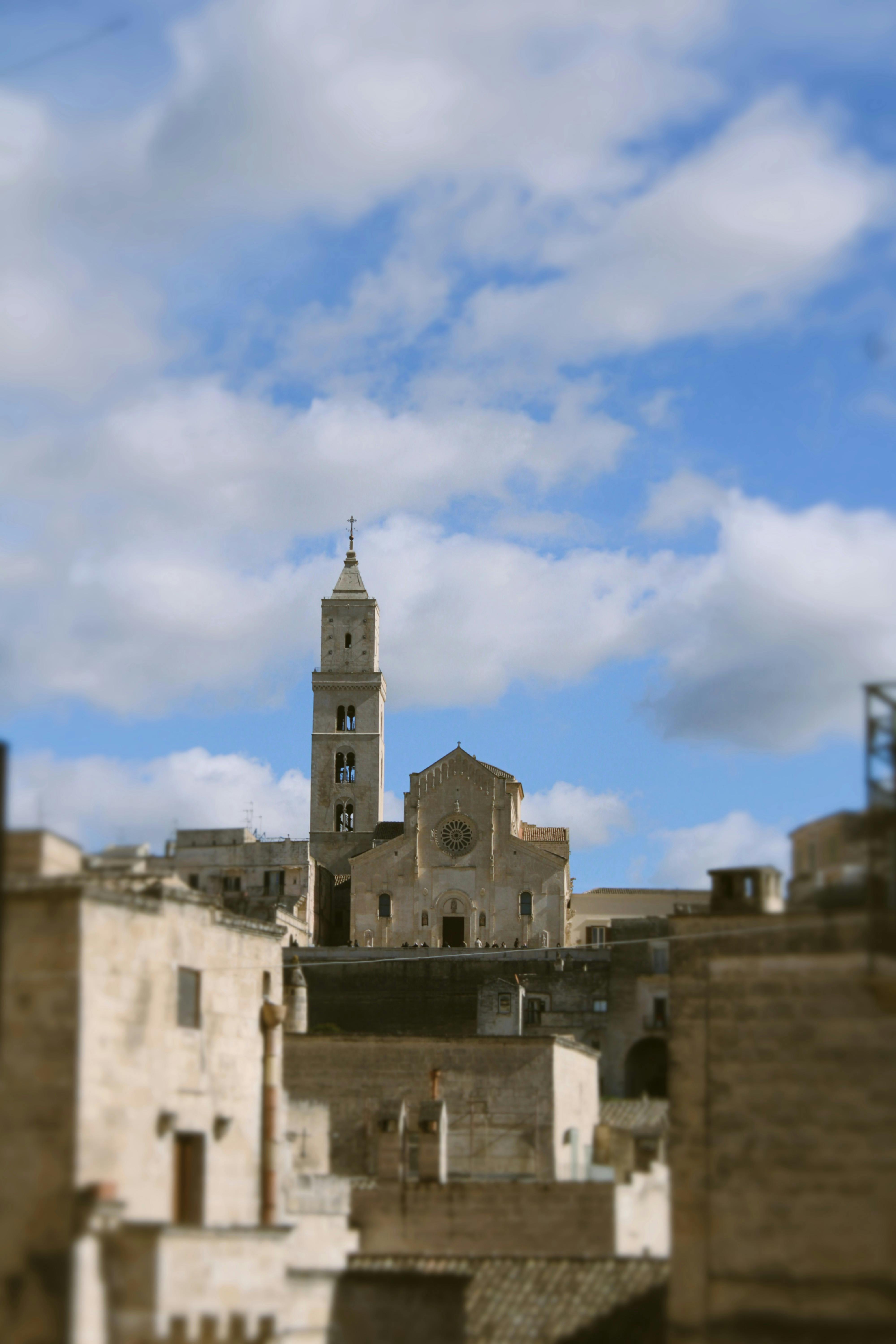 бесплатная Вид на культовые каменные постройки Матеры под ярким небом, залитый солнечным светом. Стоковое фото