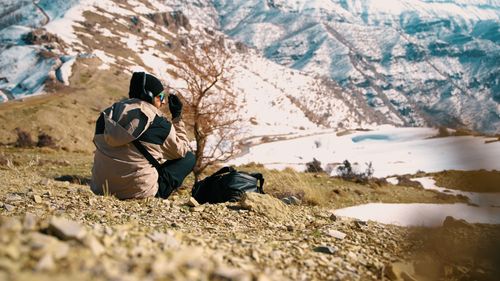 Free Person capturing the scenic snowy mountains. Winter adventure exploration. Stock Photo