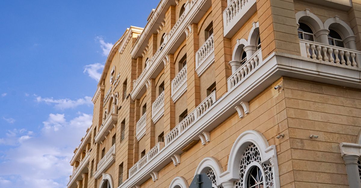 Capture of a classic architectural building facade in Saudi Arabia with clear blue skies.