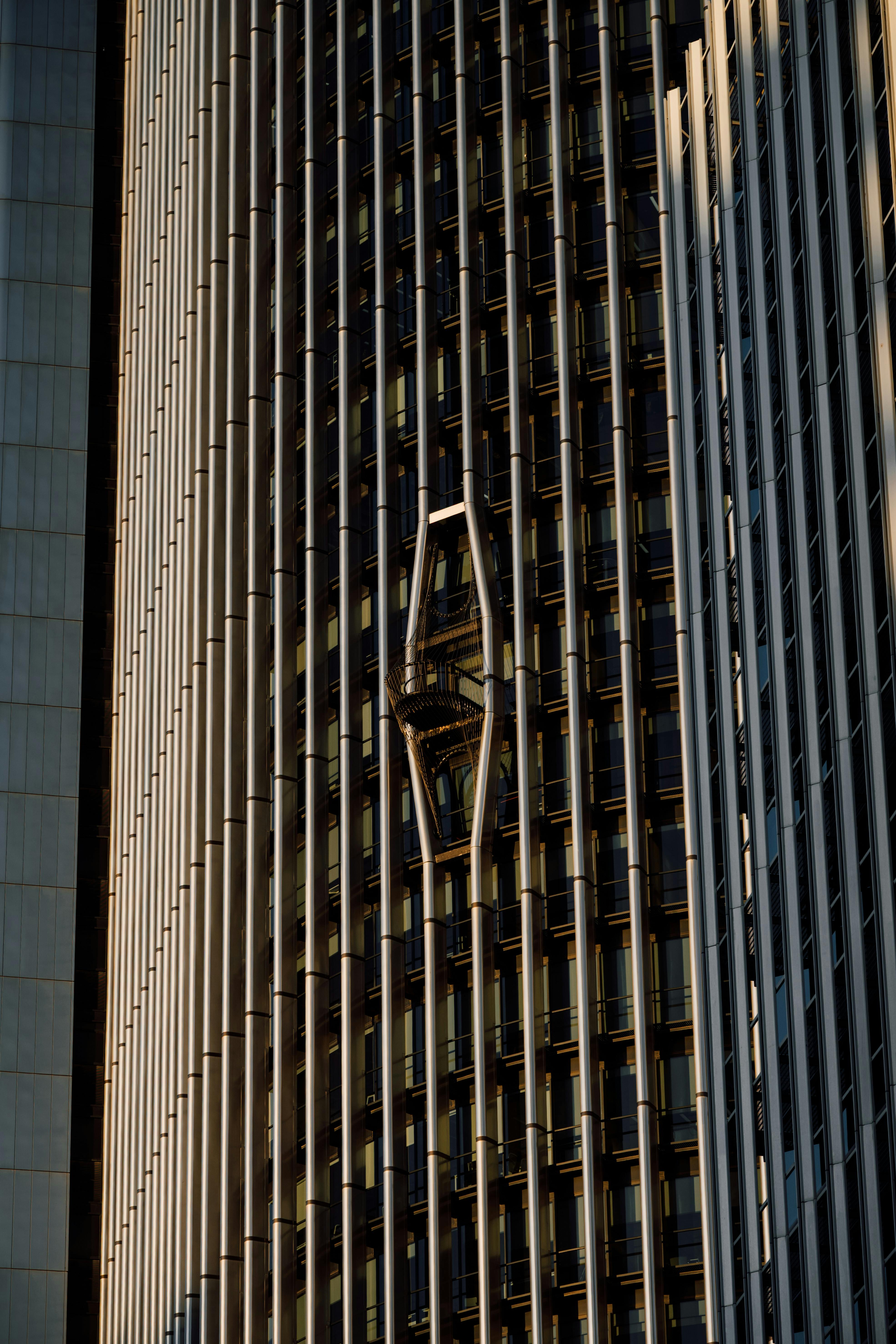 Free Close-up of a modern skyscraper facade with unique design in Madrid during daylight. Stock Photo