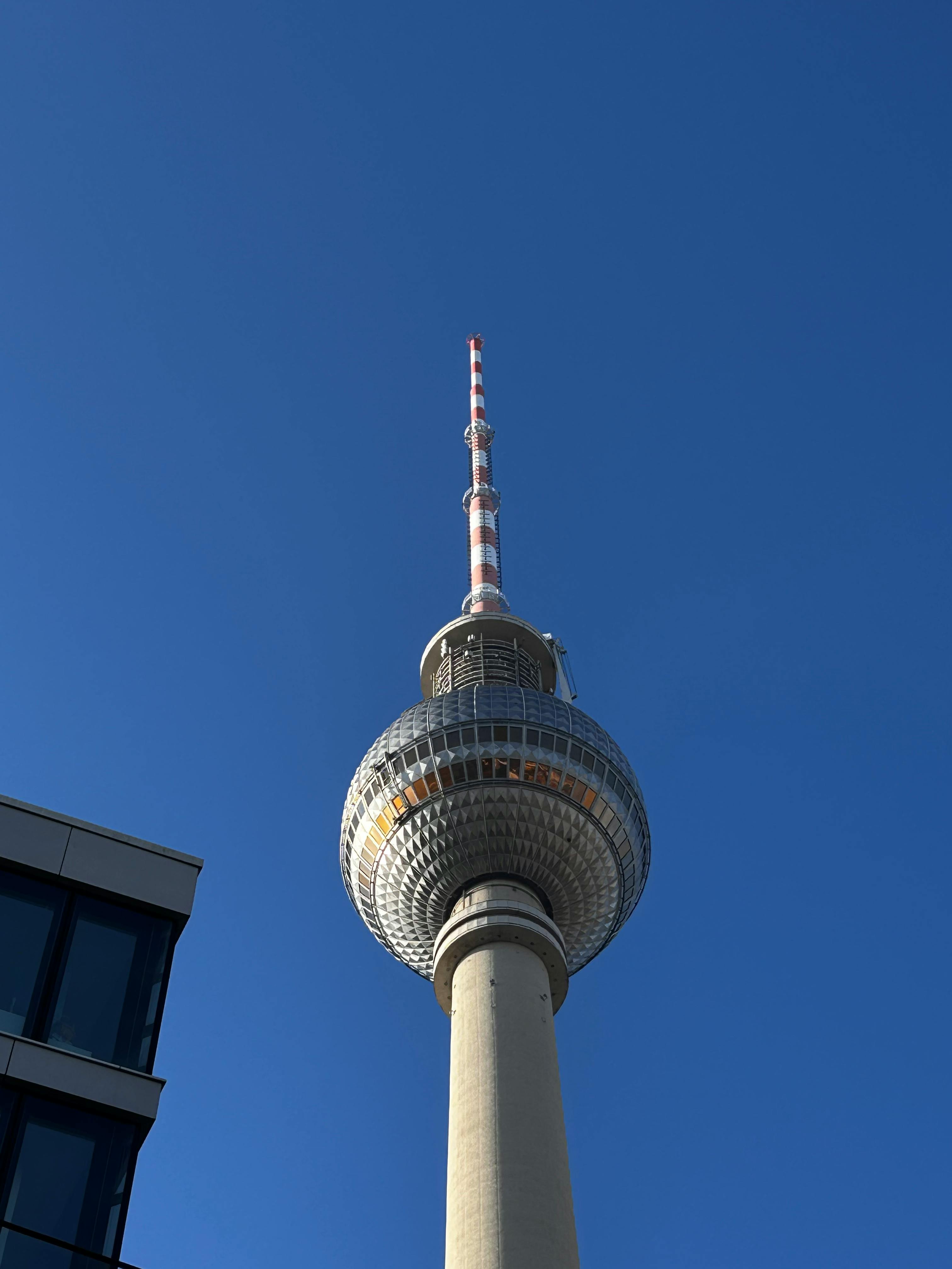Free The iconic Berlin TV Tower with a clear blue sky background, photographed from a low angle. Stock Photo