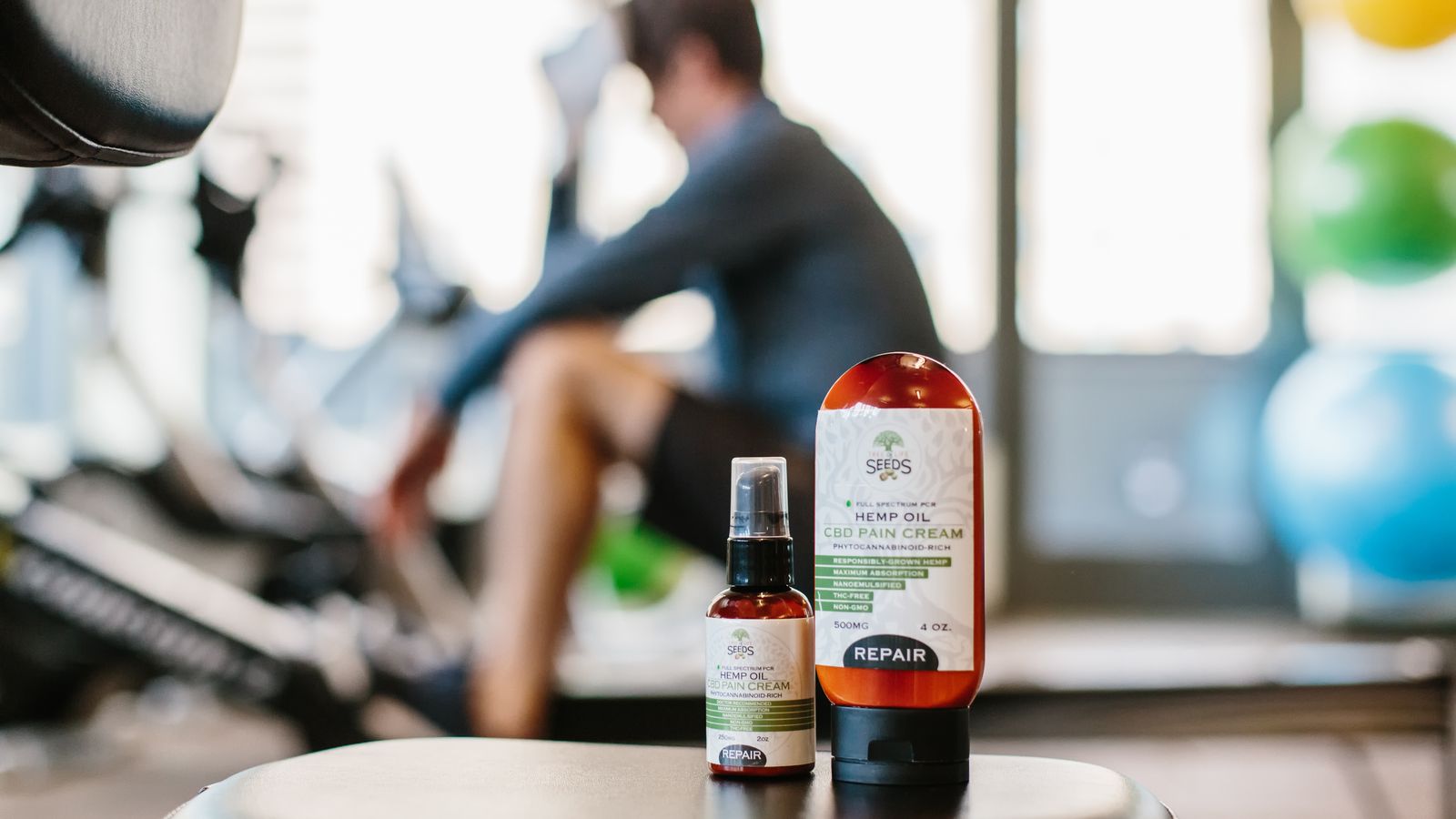 Close-up of hemp oil products in a gym focus on wellness and recovery.