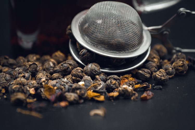 Fresh Brown Coffee Beans In Metal Strainer