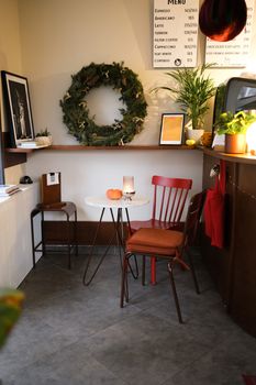 A warm and inviting cafe corner with holiday decorations, capturing the cozy essence of the season.