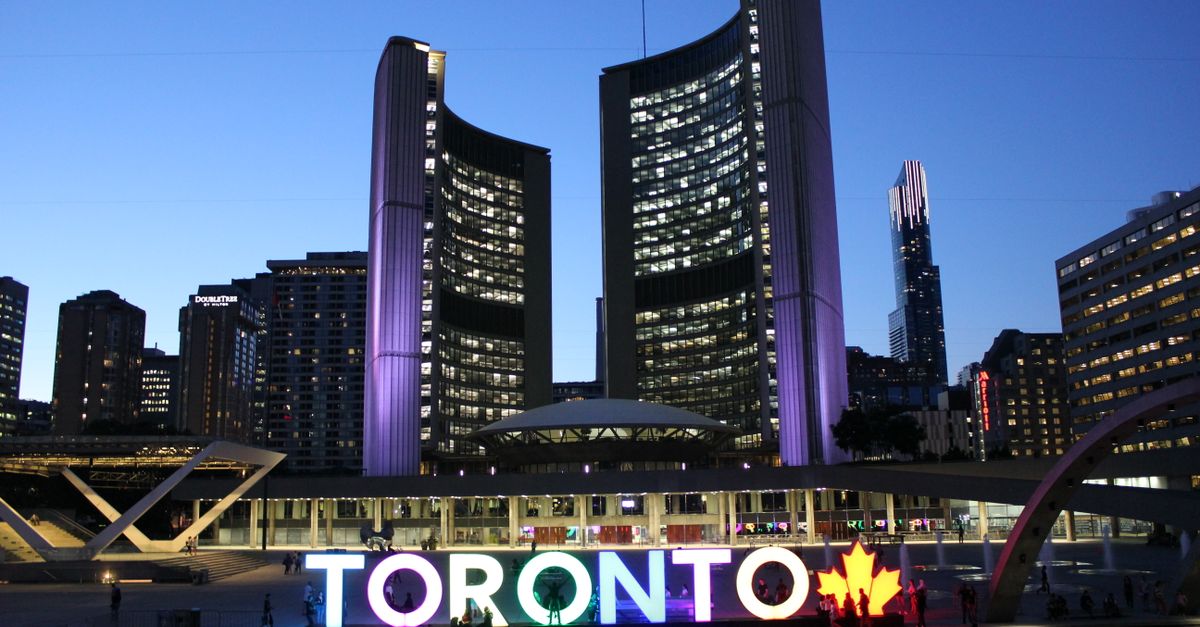 For sale sign at a Toronto condo building where investors are now selling