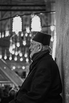 Black and white profile of an elderly man in historic building.