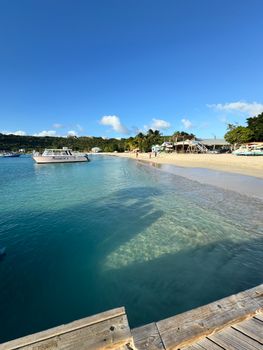 Clear turquoise waters of a Caribbean beach with a scenic landscape. Perfect for tropical vacations.